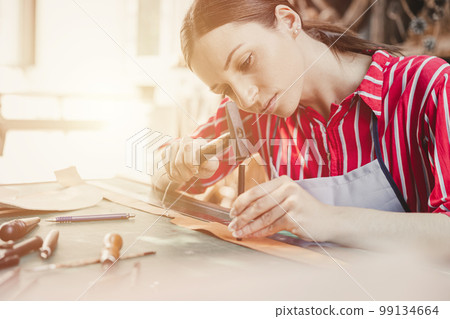 woman leather tailor artist handcraft working at own workshop small studio made by order masterwork piece woman leather tailor artist handcraft working at own workshop small studio made by order masterwork piece 99134664
