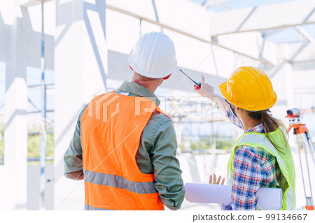 Engineer builder architect team working check roof beam construction progress structure building. 99134667