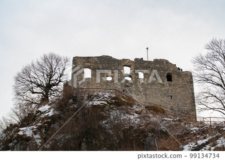Fuessen, Germany - January 14th 2023: Famous ruin Falkenstein situated on the top of a hill Fuessen, Germany - January 14th 2023: Famous ruin Falkenstein situated on the top of a hill 99134734