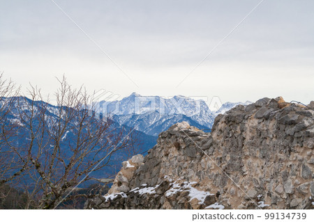 Fuessen, Germany - January 14th 2023: View from the Falkenstein ruin towards Zugspitze, the highest German peak. Fuessen, Germany - January 14th 2023: View from the Falkenstein ruin towards Zugspitze, the highest German peak. 99134739