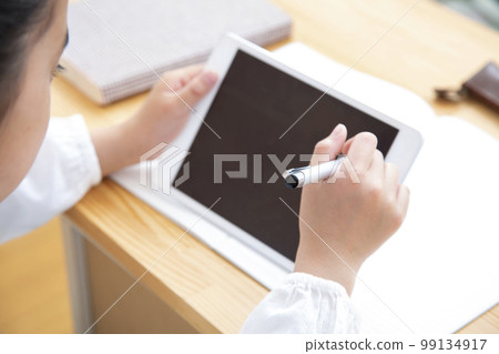 Elementary school girl studying with a tablet 99134917