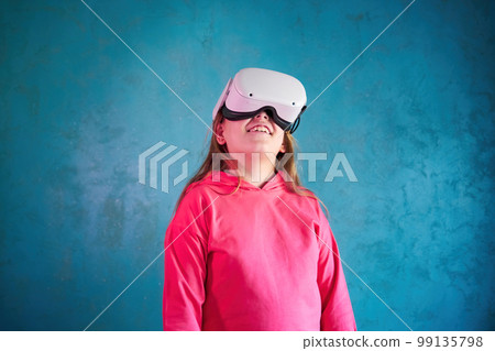 little girl playing with VR glasses 99135798