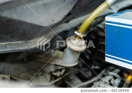 Automated change of brake fluid in a car service. Car bonnet. Automated change of brake fluid in a car service. Car bonnet. 99136449