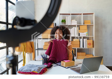 Beautiful Businesswoman start small business. A woman works from home delivering parcels online. Entrepreneurs, SME delivery concept 99138759