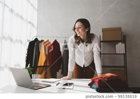 Beautiful young professional stylist working at design studio interior. fashion designer concept Beautiful young professional stylist working at design studio interior. fashion designer concept 99138819