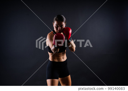 Woman do high kick, tae-bo. Athletic fit female with perfect body kick air, punching with legs 99140083