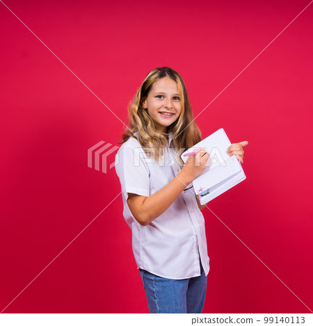 Child making notes. Kids dreams.Isolated on red background. Education, Kid back to school. 99140113