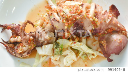 grilled squid dressing spicy and sour lemon sauce on plate 99140646