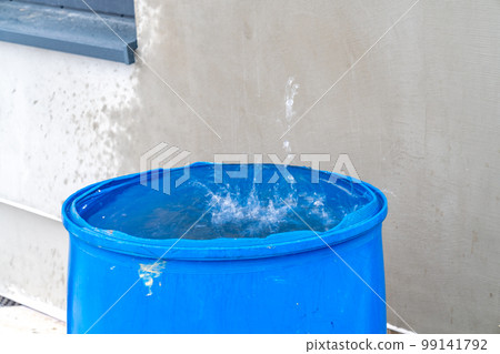 rainwater in a barrel in front of the house rainwater in a barrel in front of the house 99141792