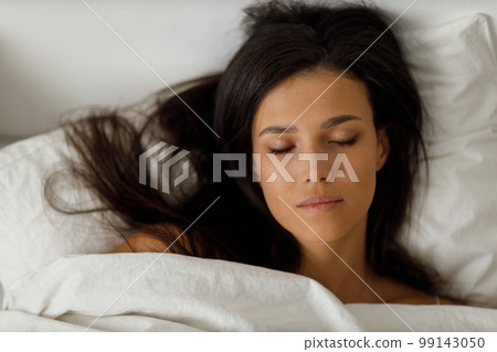Healthy young woman dressing nightie lying on bed in bedroom. Healthy young woman dressing nightie lying on bed in bedroom. 99143050
