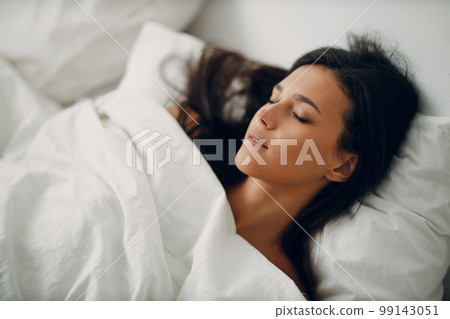 Healthy young woman dressing nightie lying on bed in bedroom. Healthy young woman dressing nightie lying on bed in bedroom. 99143051