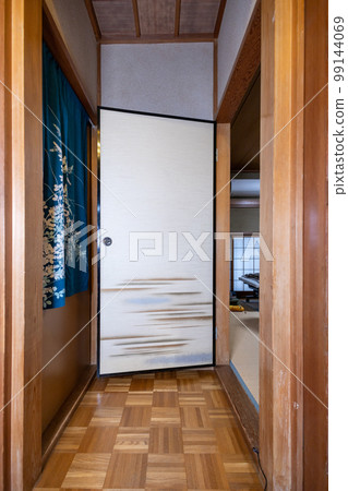 Corridor leading to a Japanese-style room and fusuma at the entrance of a Japanese-style room in an old house Corridor leading to a Japanese-style room and fusuma at the entrance of a Japanese-style room in an old house 99144069