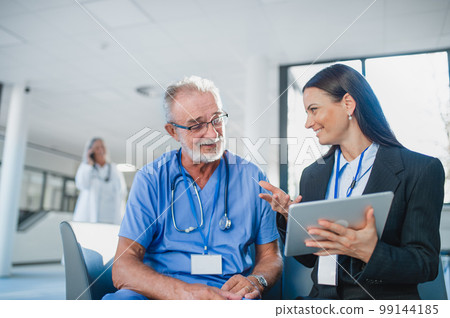 Young business woman shaking hand with elderly doctor. 99144185