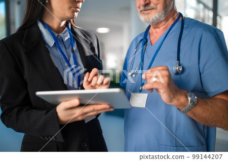 Young business woman shaking hand with elderly doctor. 99144207