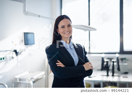 Portrait of young woman director in hospital room. Portrait of young woman director in hospital room. 99144221