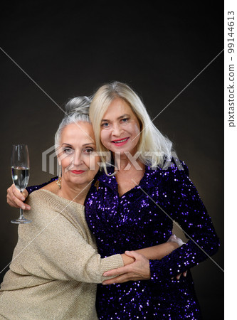 Portrait of happy senior friends with glass of wine, celebrating concept. 99144613
