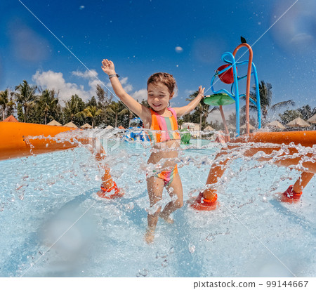 Little girl enjoying water amusement park at family vacation. Little girl enjoying water amusement park at family vacation. 99144667