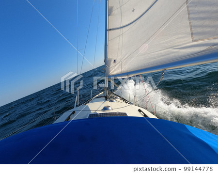 Sailboat against storm and waves in open sea. Concept of travel, adventure and vacation. Sailboat against storm and waves in open sea. Concept of travel, adventure and vacation. 99144778