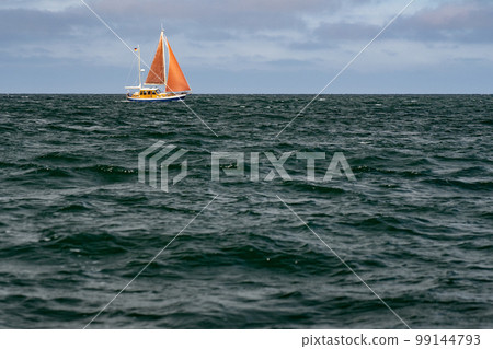 Sailboat on blue open sea with clouds on sky. Concept of travel, adventure and vacation. Sailboat on blue open sea with clouds on sky. Concept of travel, adventure and vacation. 99144793