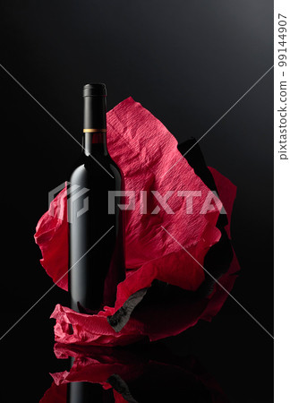 Bottle of red wine on a crumpled paper. Bottle of red wine on a crumpled paper. 99144907