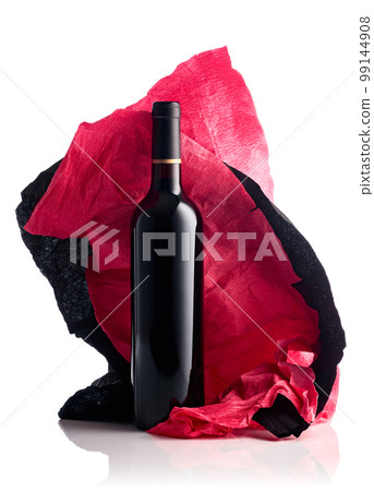 Bottle of red wine with crumpled crepe paper isolated on a white background. Bottle of red wine with crumpled crepe paper isolated on a white background. 99144908