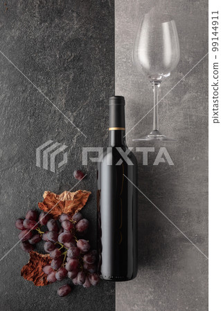 Red wine with grapes on a stone background. Red wine with grapes on a stone background. 99144911