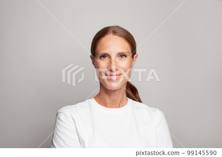 Cute mid adult woman smiling, indoor studio portrait. Female face closeup. Cute mid adult woman smiling, indoor studio portrait. Female face closeup. 99145590