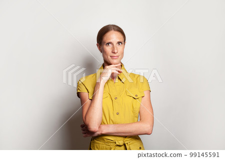 Optimistic successful mid adult business woman, studio portrait Optimistic successful mid adult business woman, studio portrait 99145591