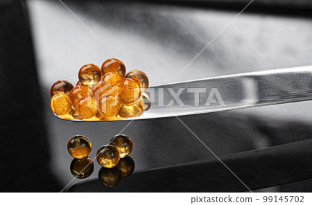 Red caviar on knife isolated on black background 99145702