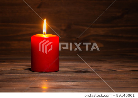 burning candle on wooden background 99146001