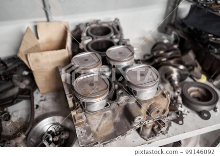 Many tools and auto spare parts car at a car repair shop. Car parts for repairs. Used vehicle part for recycling in the scrap yard garage. Many tools and auto spare parts car at a car repair shop. Car parts for repairs. Used vehicle part for recycling in the scrap yard garage. 99146092