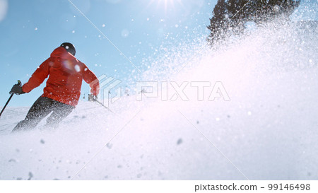 Free ride skier running down the hill. 99146498