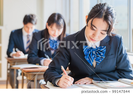 High school students wearing uniforms studying in the classroom High school students wearing uniforms studying in the classroom 99147844