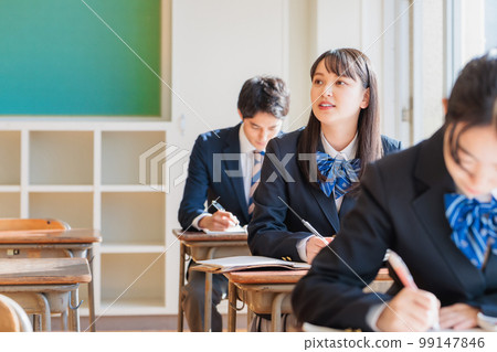High school students wearing uniforms studying in the classroom High school students wearing uniforms studying in the classroom 99147846