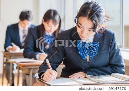 High school students wearing uniforms studying in the classroom High school students wearing uniforms studying in the classroom 99147878