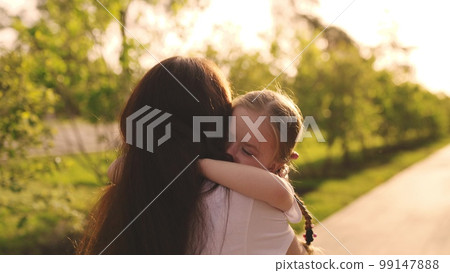 happy family. young mother hugs small child running merrily into arm. childhood dream kid.child run around park towards mother. girl daughter with cheerful mom hugging park. maternal happiness woman. 99147888