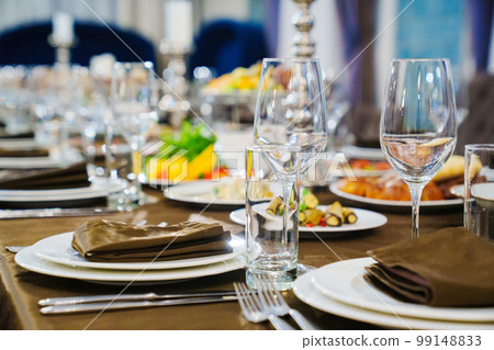 a festive served table with snacks and tableware. 99148833