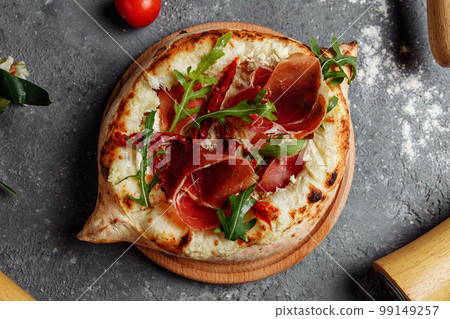 Ajarian traditional flatbread - khachapuri or hachapuri with with jamon, cheese and herbs 99149257