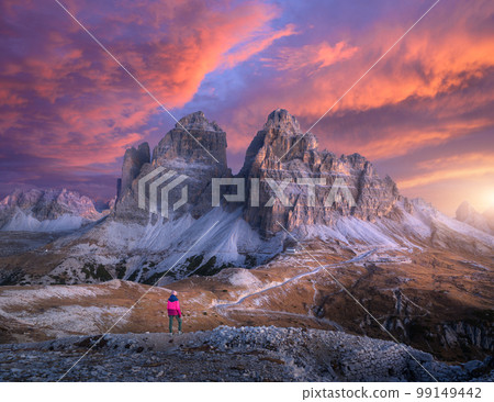 Woman on the hill and mountain peaks at colorful sunset in autum 99149442