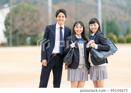 High school girls and boys lined up in the schoolyard High school girls and boys lined up in the schoolyard 99149875