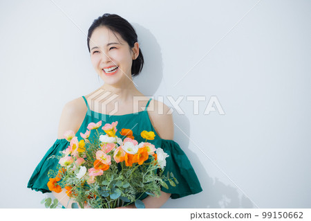 A woman holding a bouquet of poppies 99150662