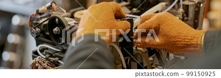 Male electrician hands repairing coffee machine in workshop 99150925