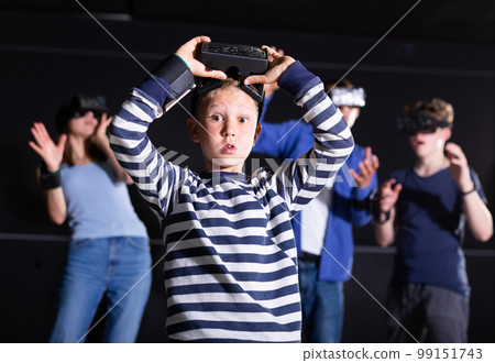 Portrait of a boy who took off his virtual reality glasses Portrait of a boy who took off his virtual reality glasses 99151743