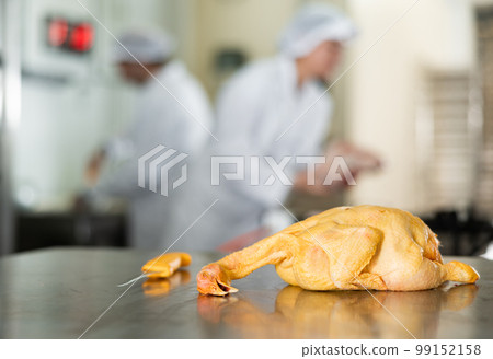 Raw dressed chicken lying on cutting table of butchers shop Raw dressed chicken lying on cutting table of butchers shop 99152158