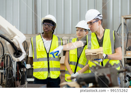 Team engineer man and woman talking and explaining about robot arms technology intelligence. 99155262