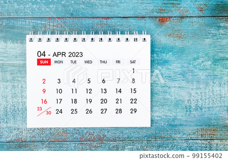 The April 2023 Monthly desk calendar for 2023 year on old blue wooden background. 99155402