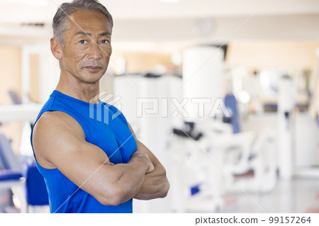 A middle-aged man folding his arms at the gym A middle-aged man folding his arms at the gym 99157264