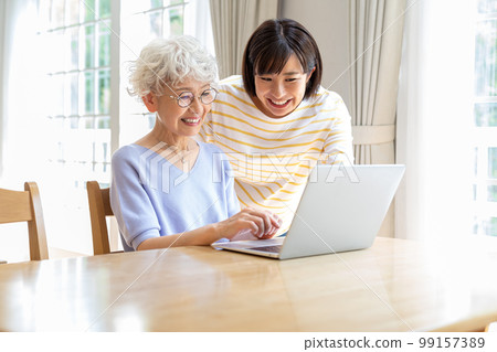 Senior woman learning computer in living room 99157389