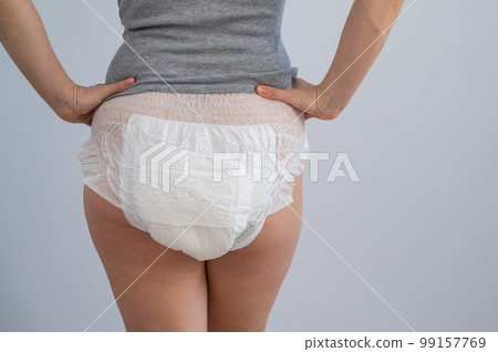 Rear view of a woman in adult diapers. Incontinence problem. 99157769