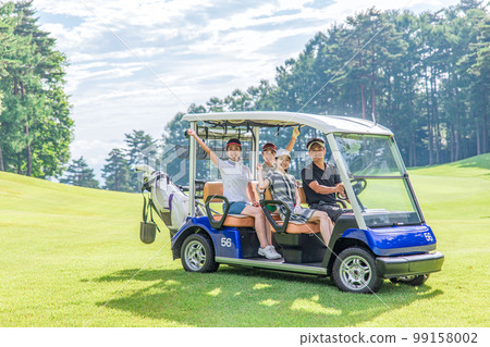 Golfer man and woman riding a golf cart on a golf course Golfer man and woman riding a golf cart on a golf course 99158002